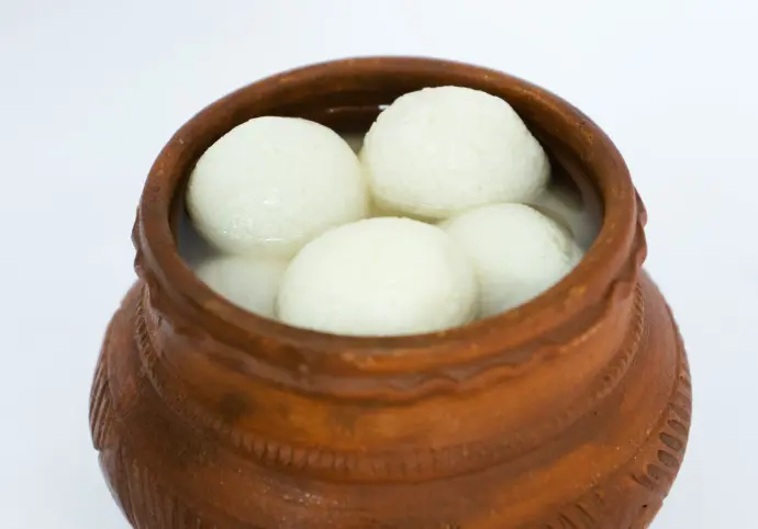 a wooden bowl filled with white balls of food